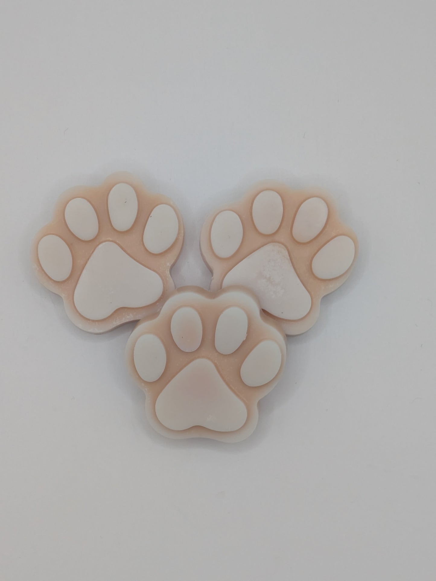 Three paw print shapes on a light gray background